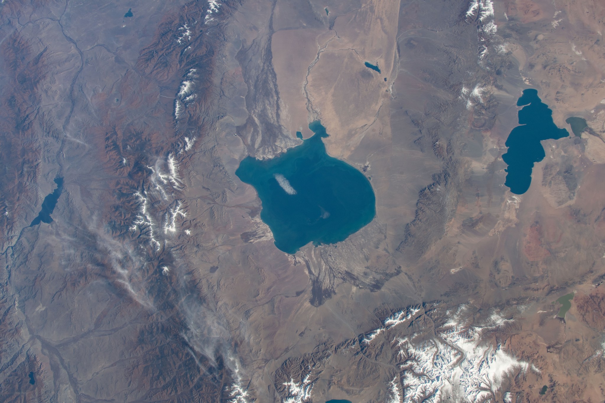 iss070e003079 (Oct. 12, 2023) -- As the International Space Station orbited 260 miles above, two high saline lakes Uvs (left) and Khyargas (right) located in the Northwestern region of Mongolia were photographed. Both basins are nestled amongst mountain regions home to many different ecosystems.