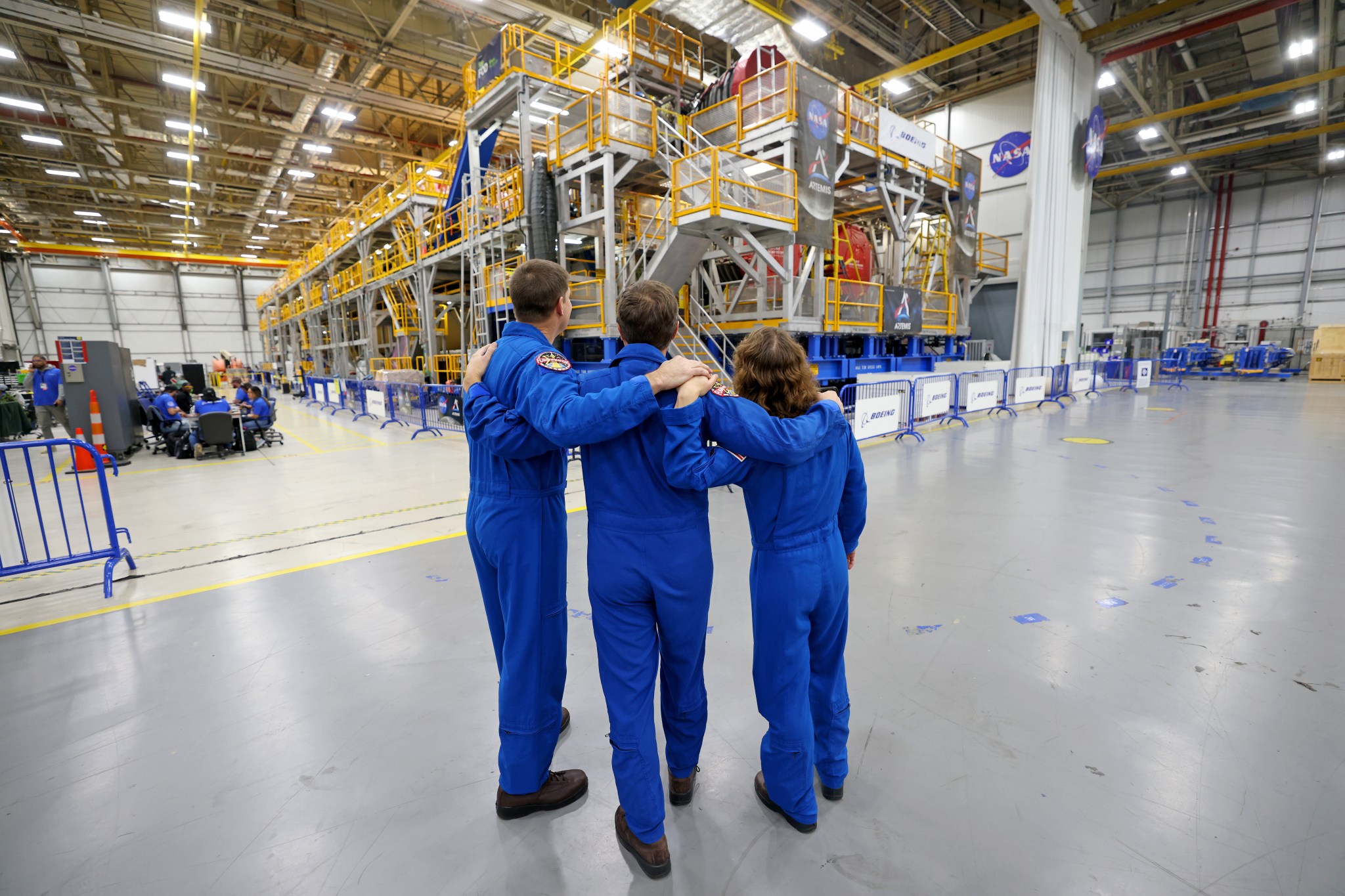 Artemis II NASA astronauts Reid Wiseman and Christina Koch of NASA, and CSA (Canadian Space Agency) astronaut Jeremy Hansen view the core stage for the SLS (Space Launch System) rocket at the agency’s Michoud Assembly Facility in New Orleans on Nov. 16.