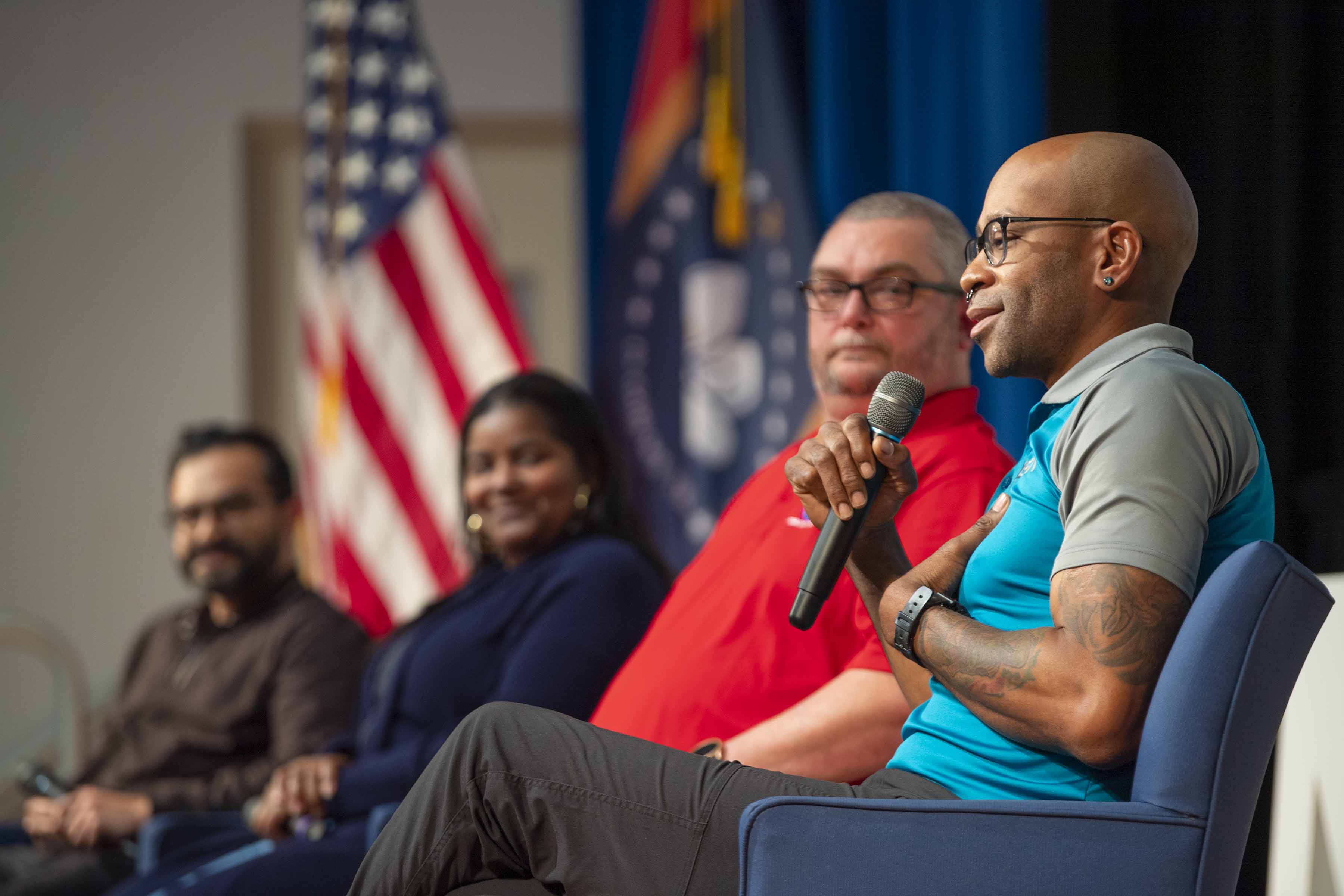 NASA Stennis Autonomous Systems Laboratory technical project manager Travis Martin, wearing a blue polo shirt with gray sleeves, speaks during a Next Gen STEM Explore Stennis event