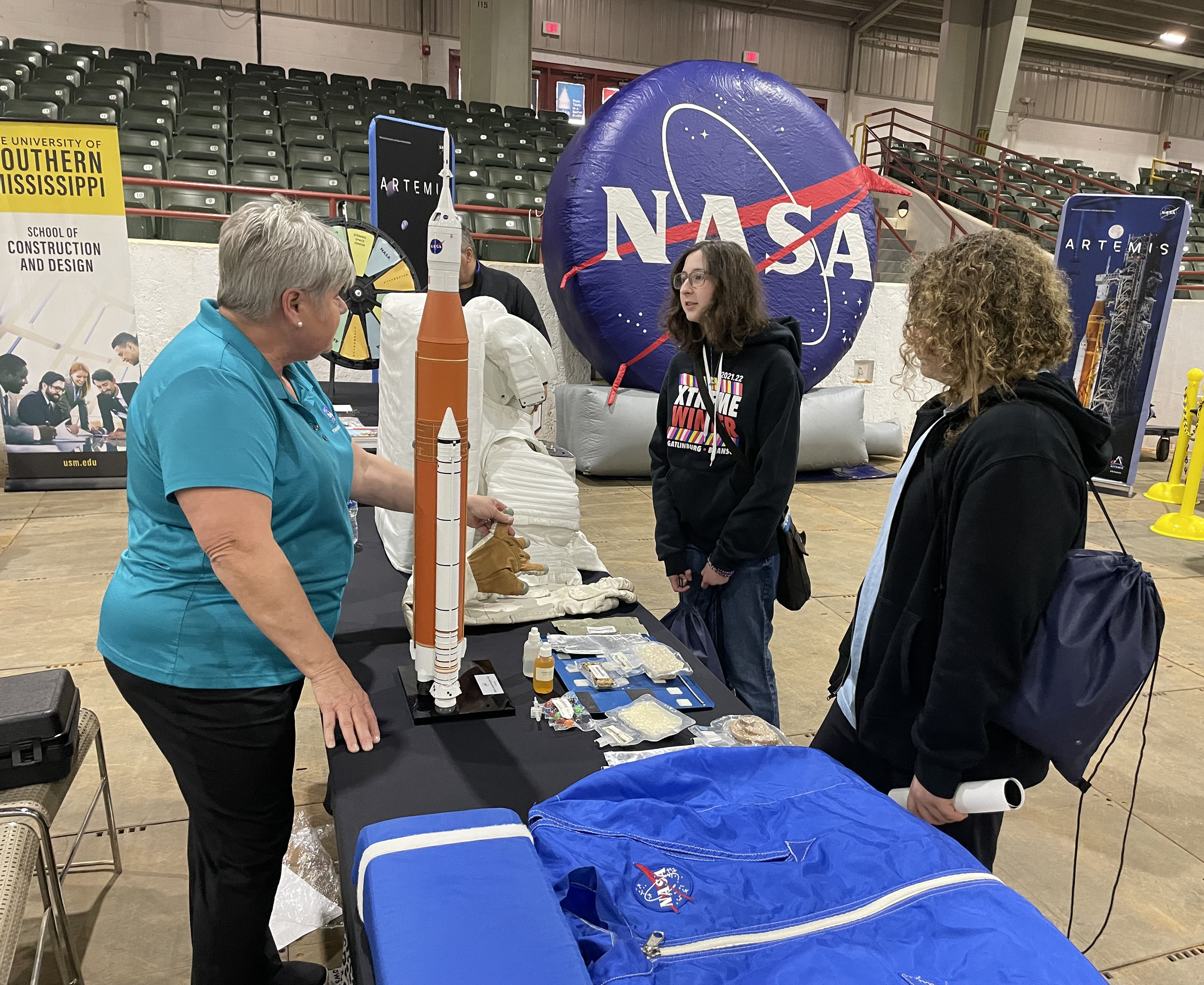 two students observed at a vendor booth