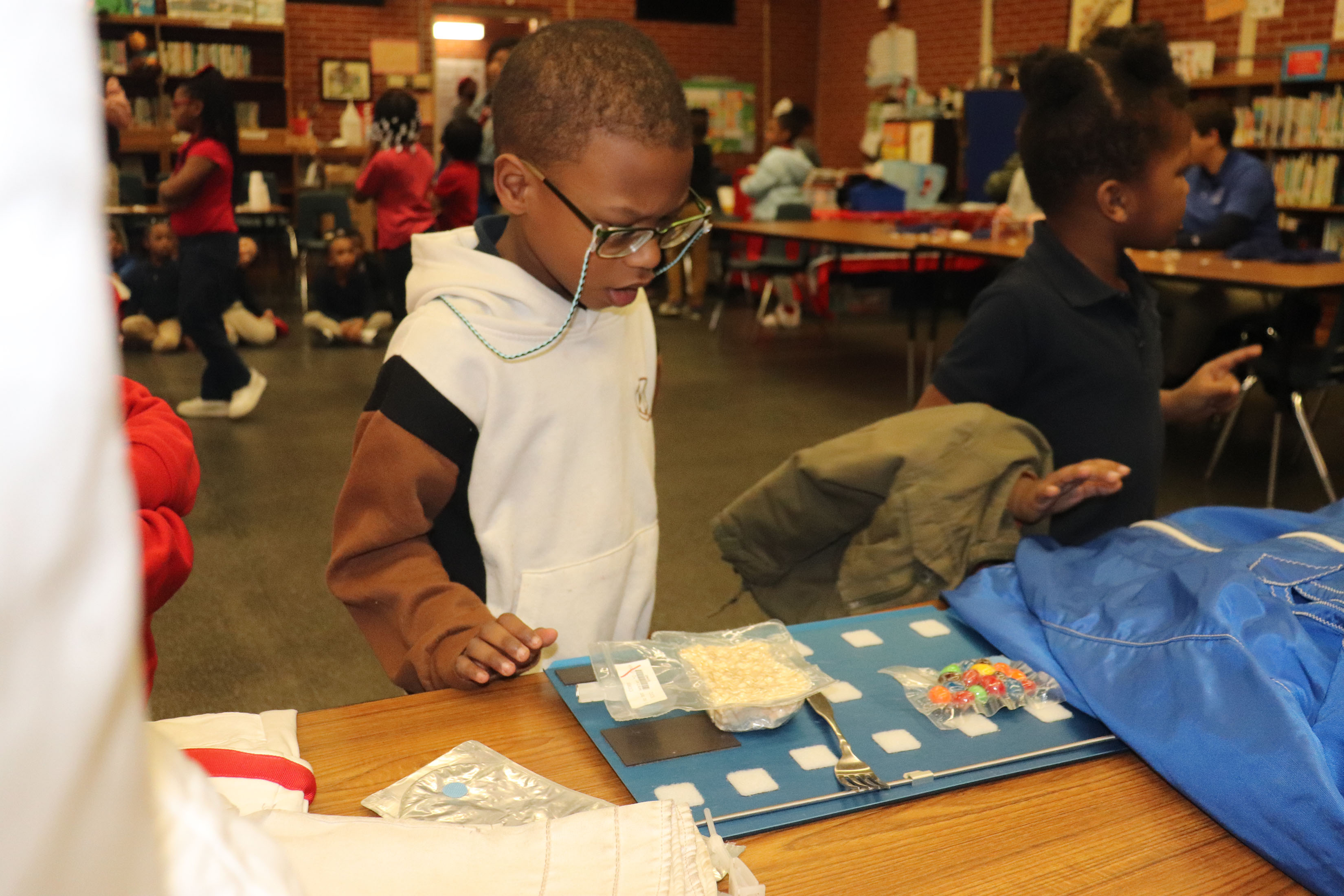 young student observes space food display