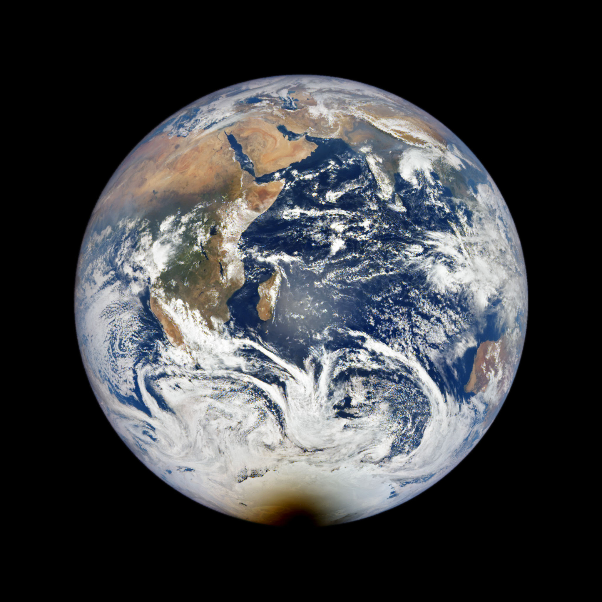 View of the eclipse over Antarctica in December 2021, from the Expedition 66 crew aboard the space station, left, and from the Deep Space Climate Observatory (DSCOVR) satellite