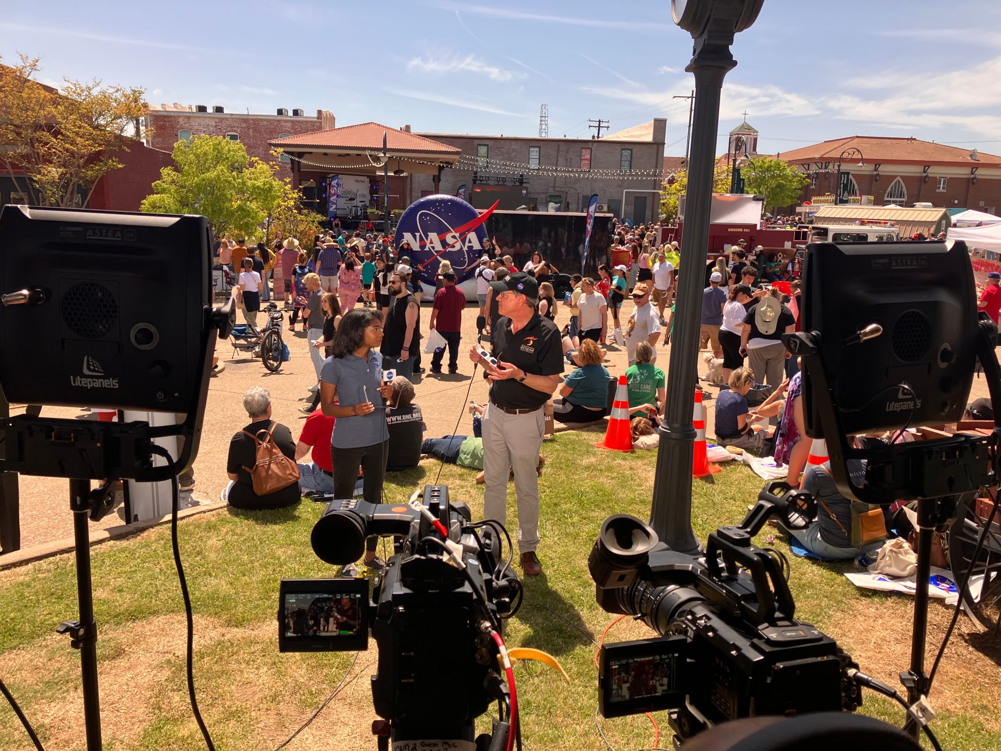 NASA broadcast host Jasmine Hopkins, center left, and NASA Research and Analysis Lead for Heliophysics Patrick Koehn, center right, provide live commentary during the agency’s eclipse broadcast from Russellville, Arkansas. The broadcast garnered more than 13 million views by Tuesday afternoon.