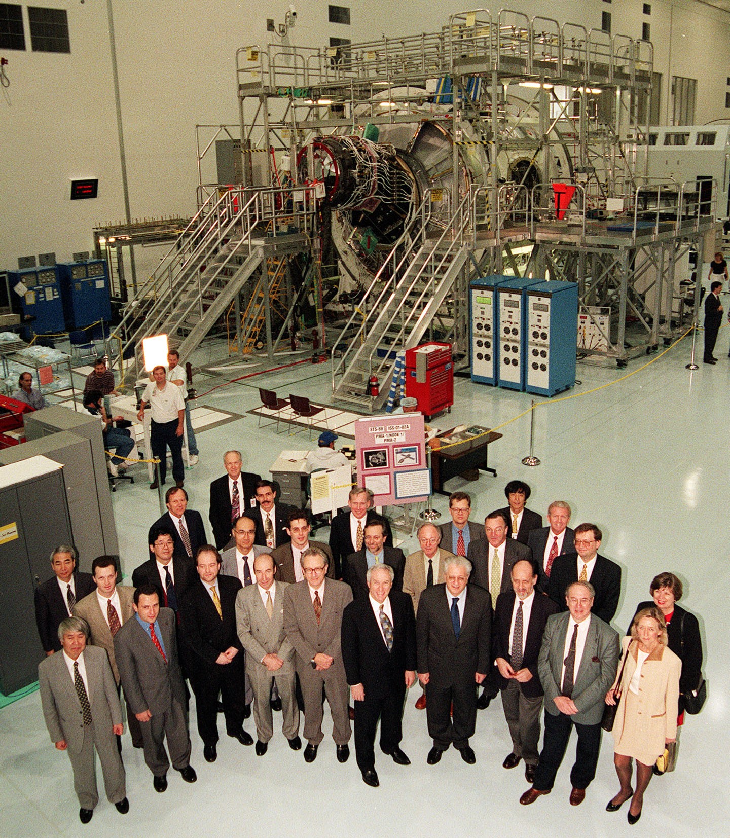 Signatories of the 1998 IGA visit the Space Station Processing Facility at NASA’s Kennedy Space Center in Florida, posing in front of the Unity Node 1 module being prepared for launch