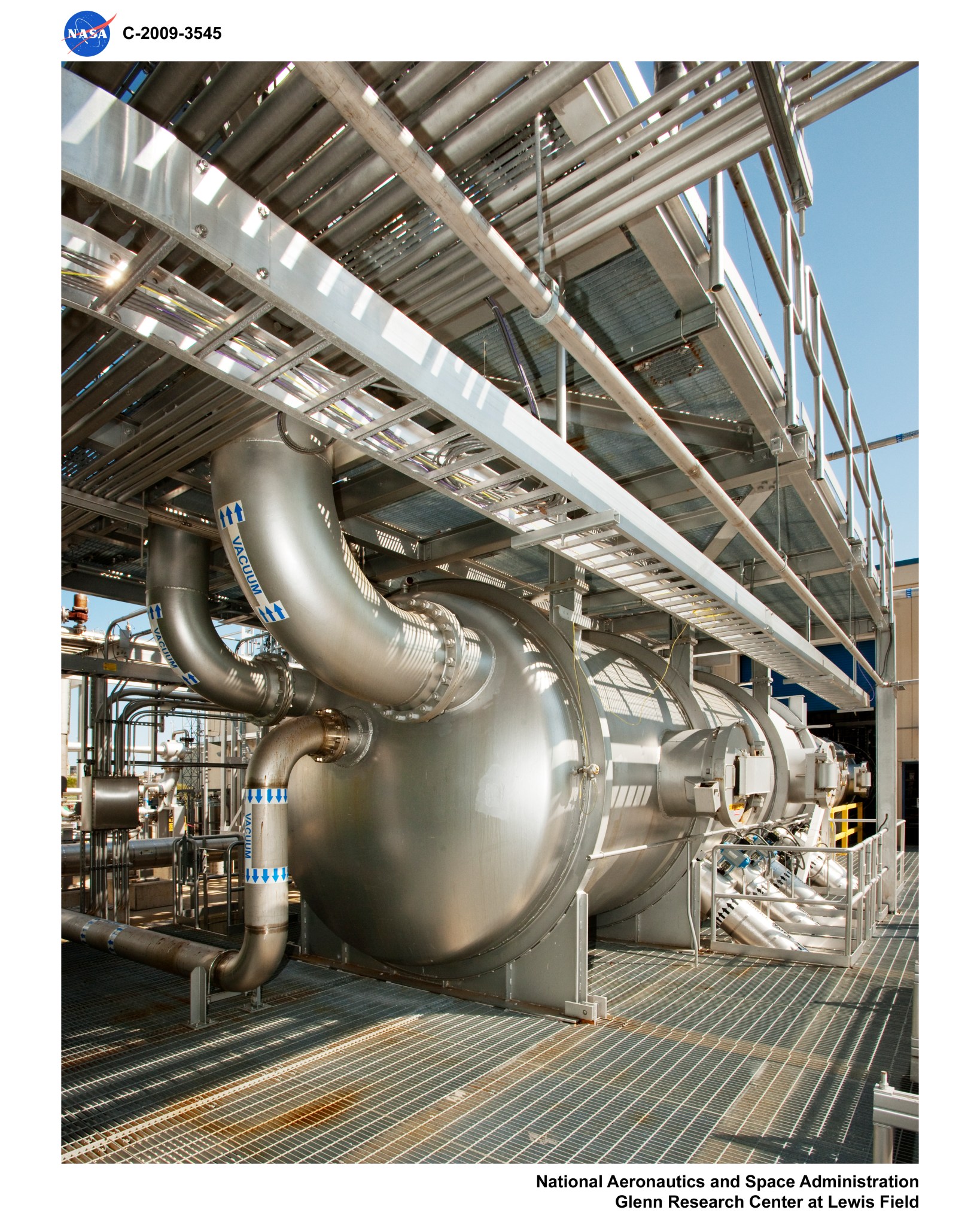 A group of metal cylinders and piping connected to a building.