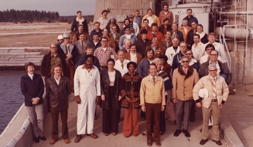 mixed crowd of people pose at the base of A-1 Test Stand