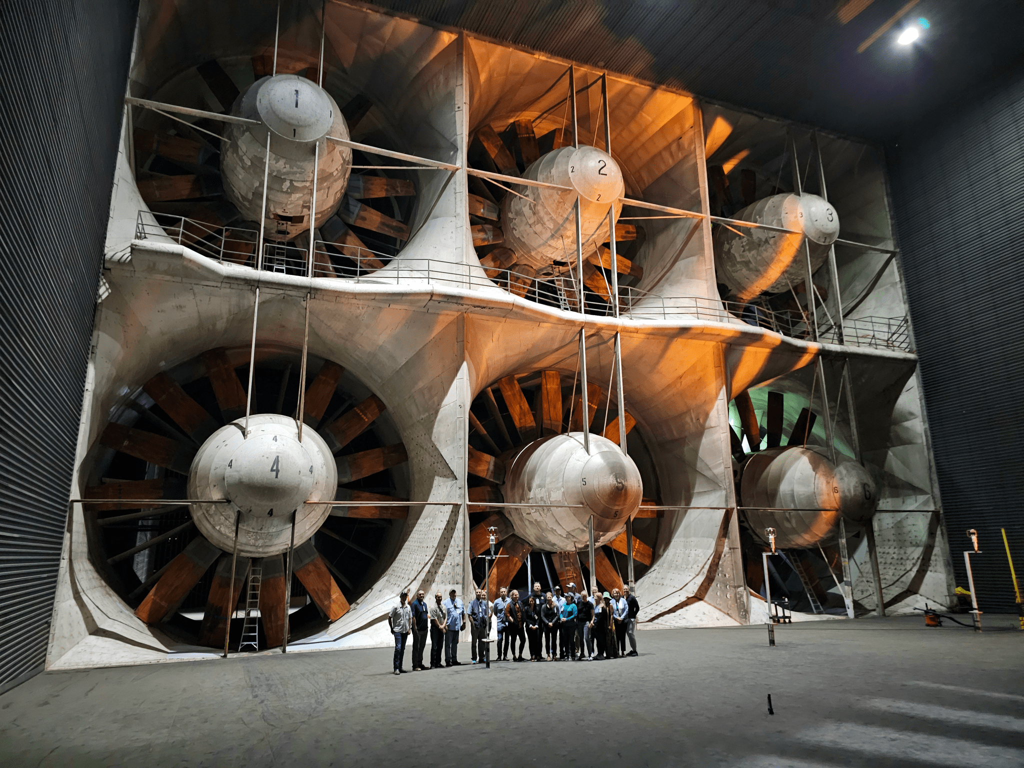 The NWCG tour concluded in the National Full Scale Aerodynamic Complex; the group provides a sense of scale for just how massive the turbines are that pull air into the 120-foot wind tunnel.