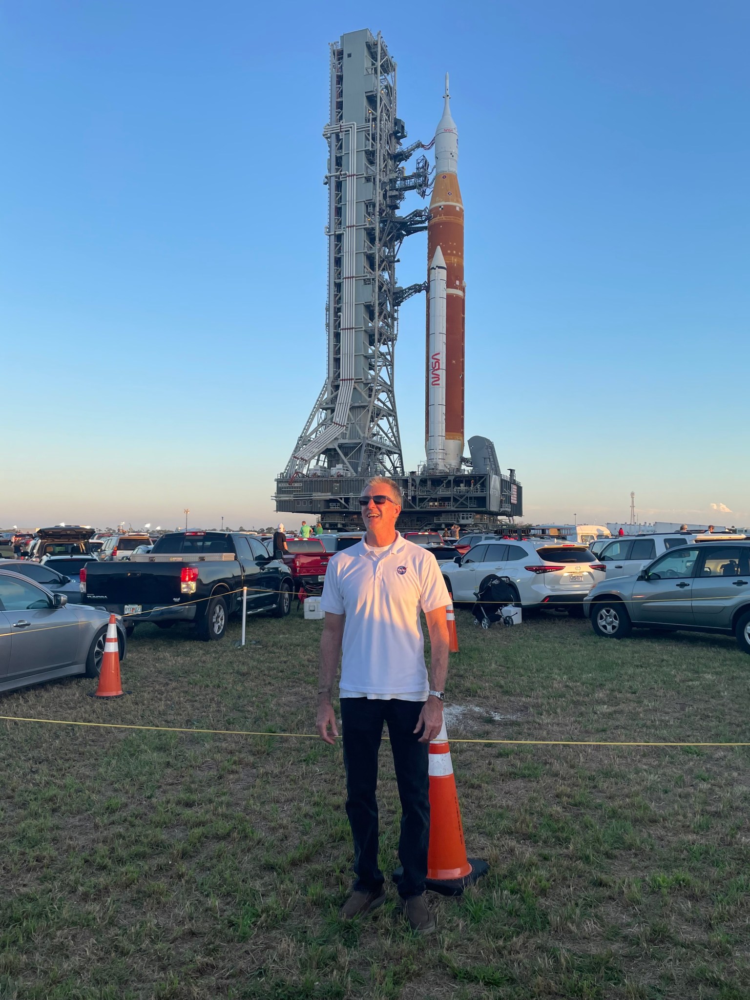 Calfee pauses for a photo in front of the SLS rocket ahead of the Artemis I launch in 2022.