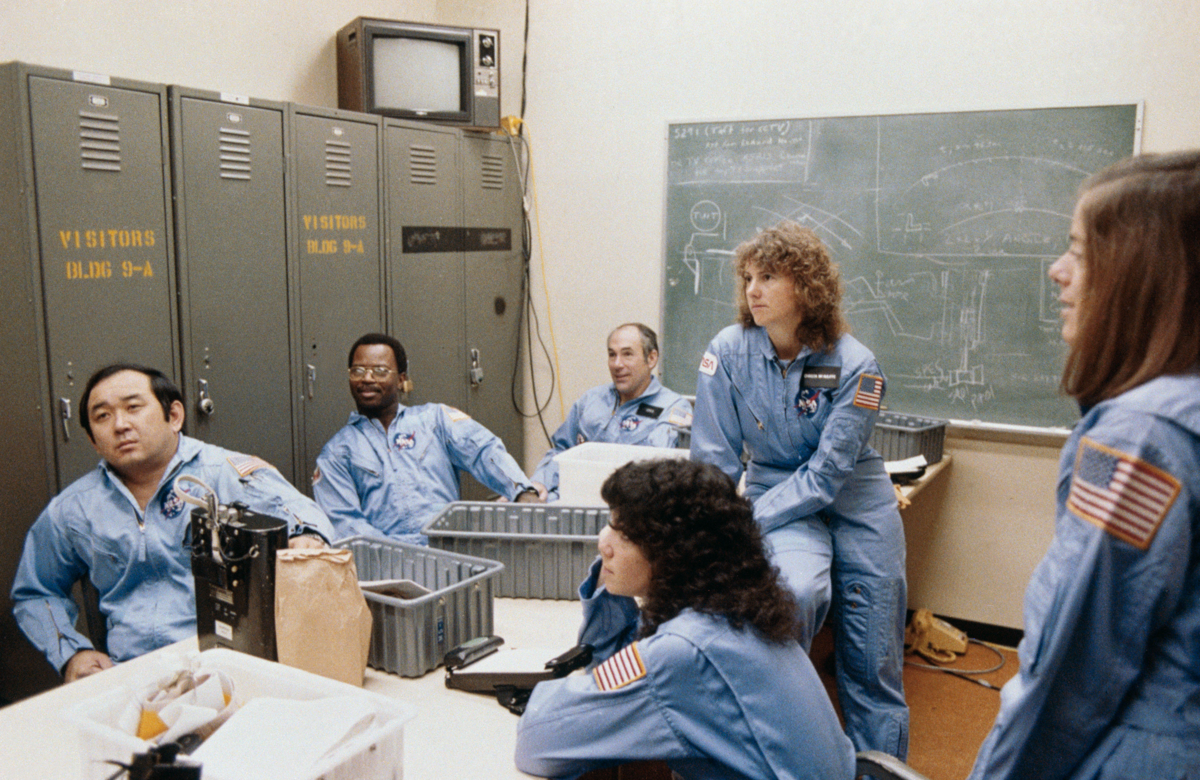 The STS-51L crew receives a briefing on crew escape procedures