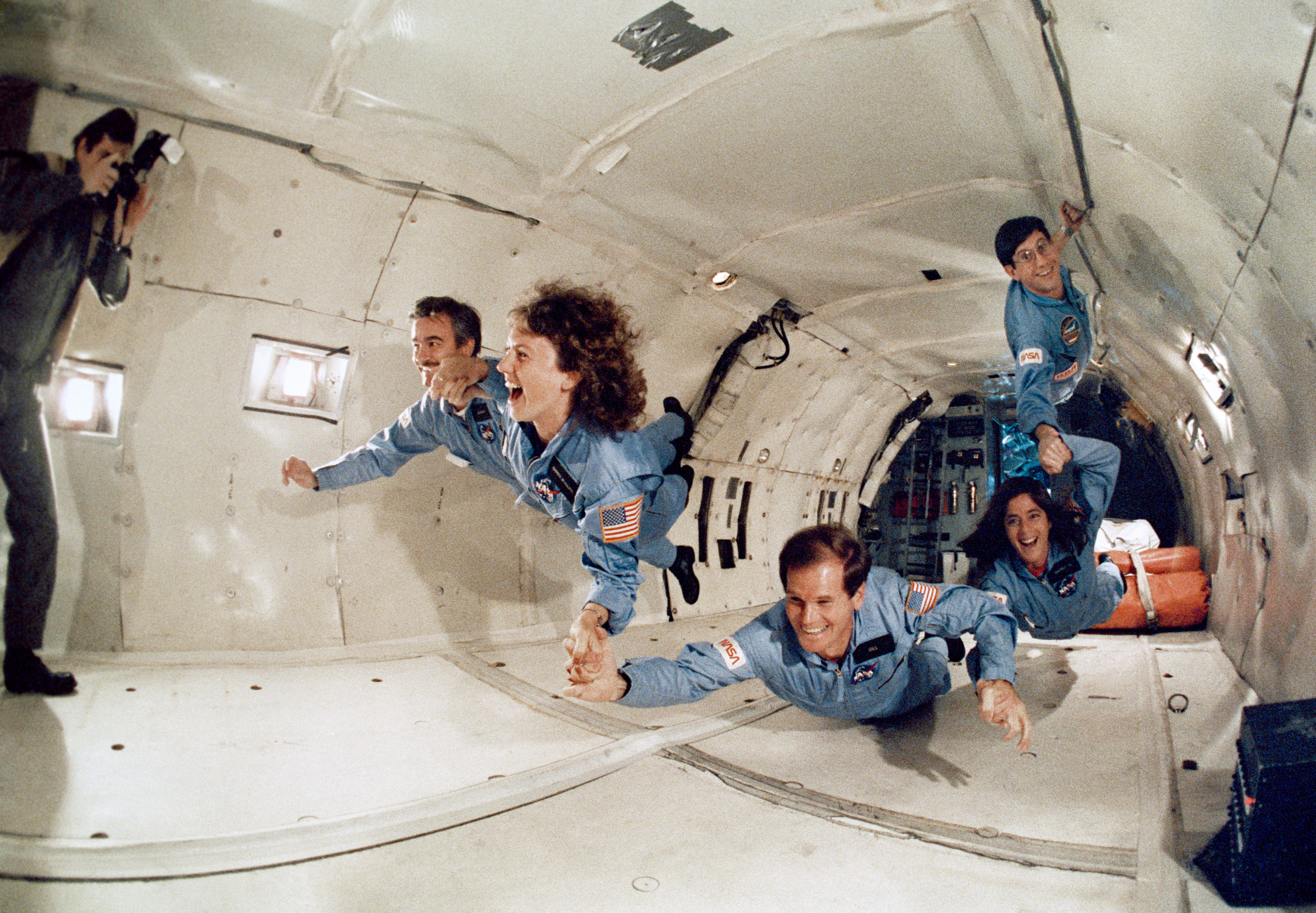 Teacher in Space McAuliffe, second from left, and her backup Morgan, get a taste of weightlessness aboard NASA’s KC-135, along with STS-61C Payload Specialist Congressman C. William “Bill” Nelson, now serving as NASA’s 14th administrator