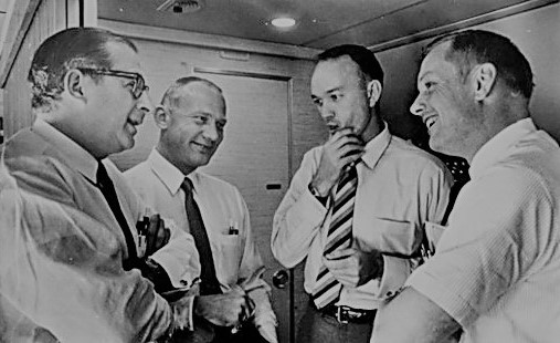 Aug. 14, 1969. NASA Administrator Thomas O. Paine, left, accompanies Buzz, Mike, and Neil on the plane back to Houston