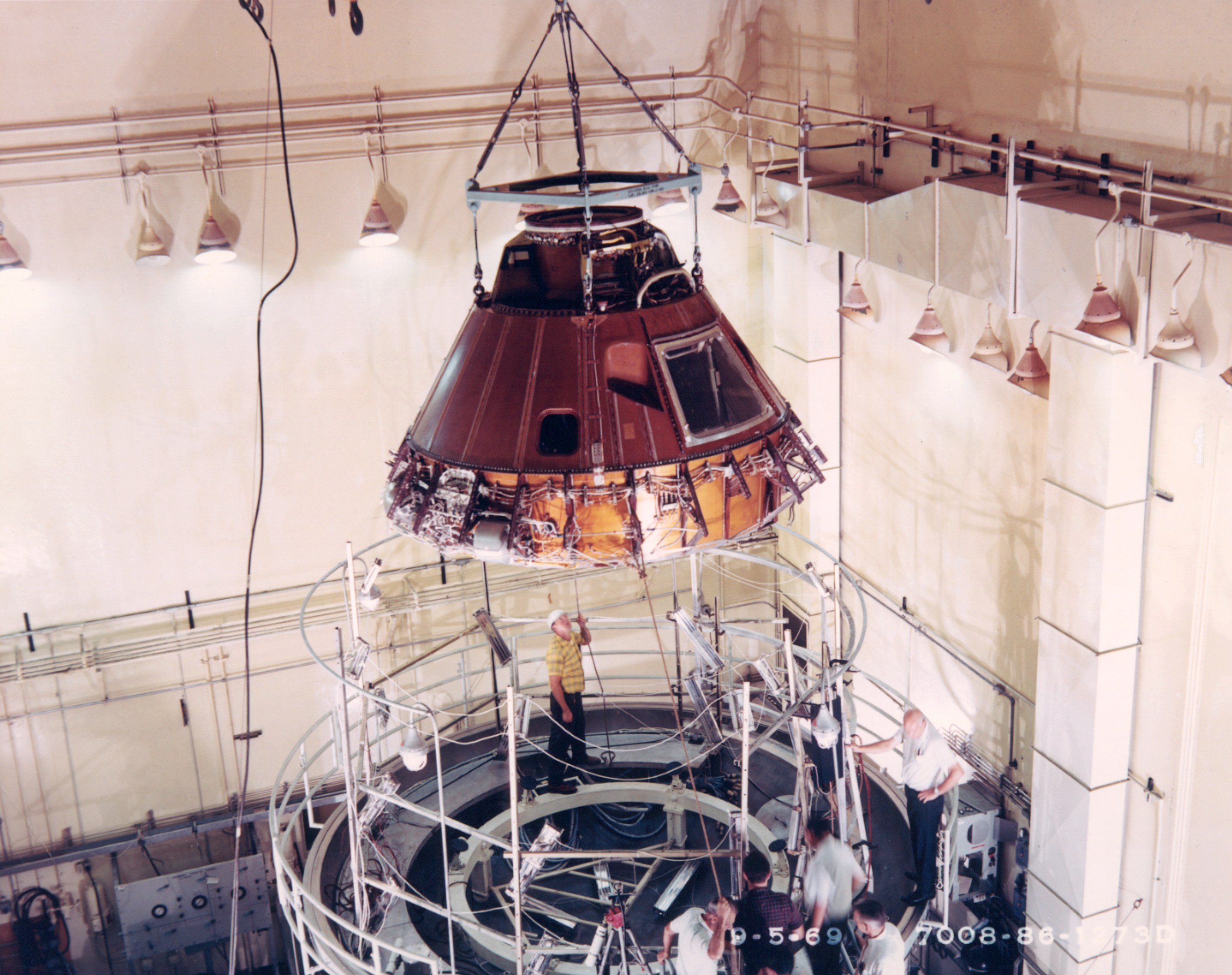 Workers prepare to place Columbia in a chamber to bakeout any residual moisture to ready it for public display