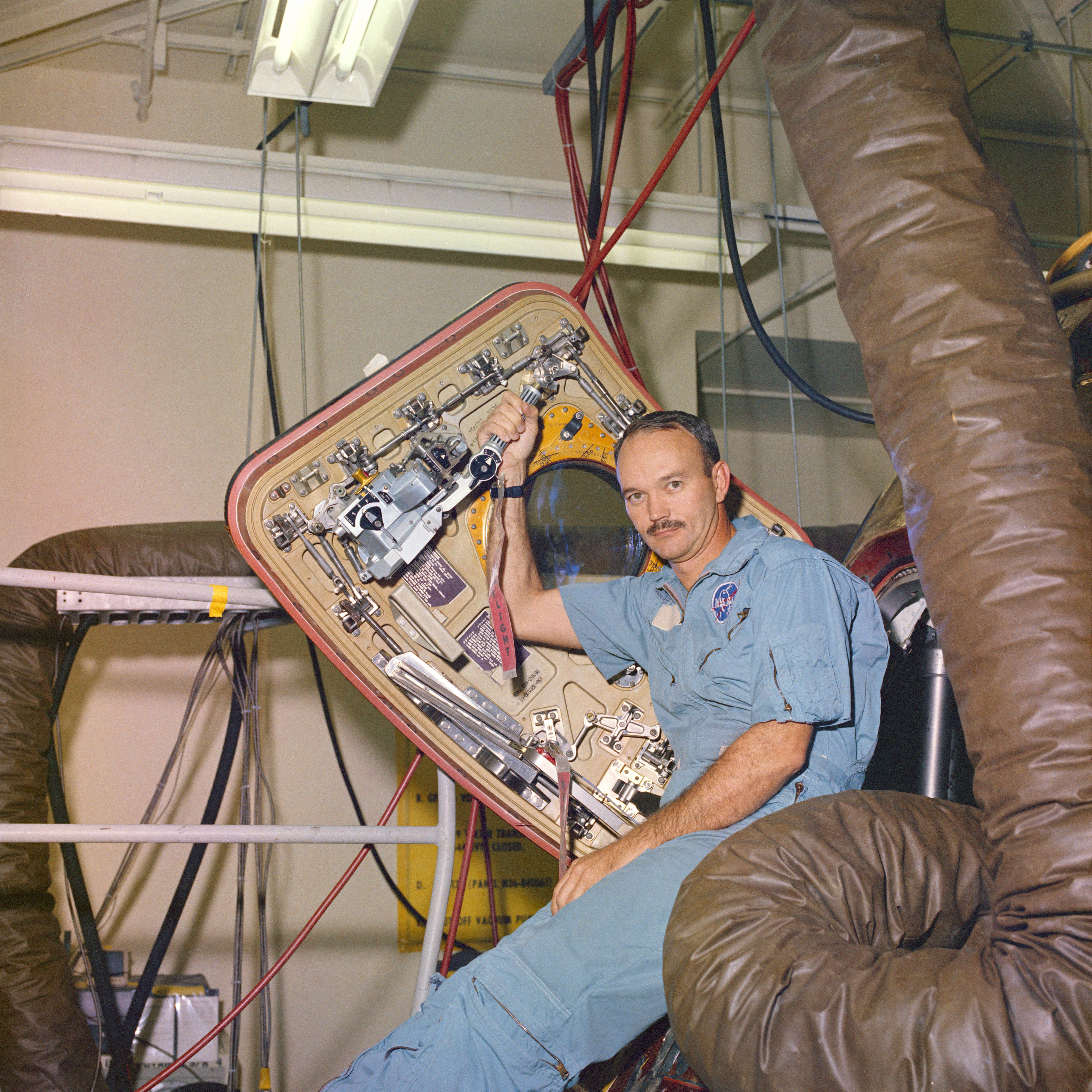 Mike Collins sits in Columbia’s hatch in the LRL