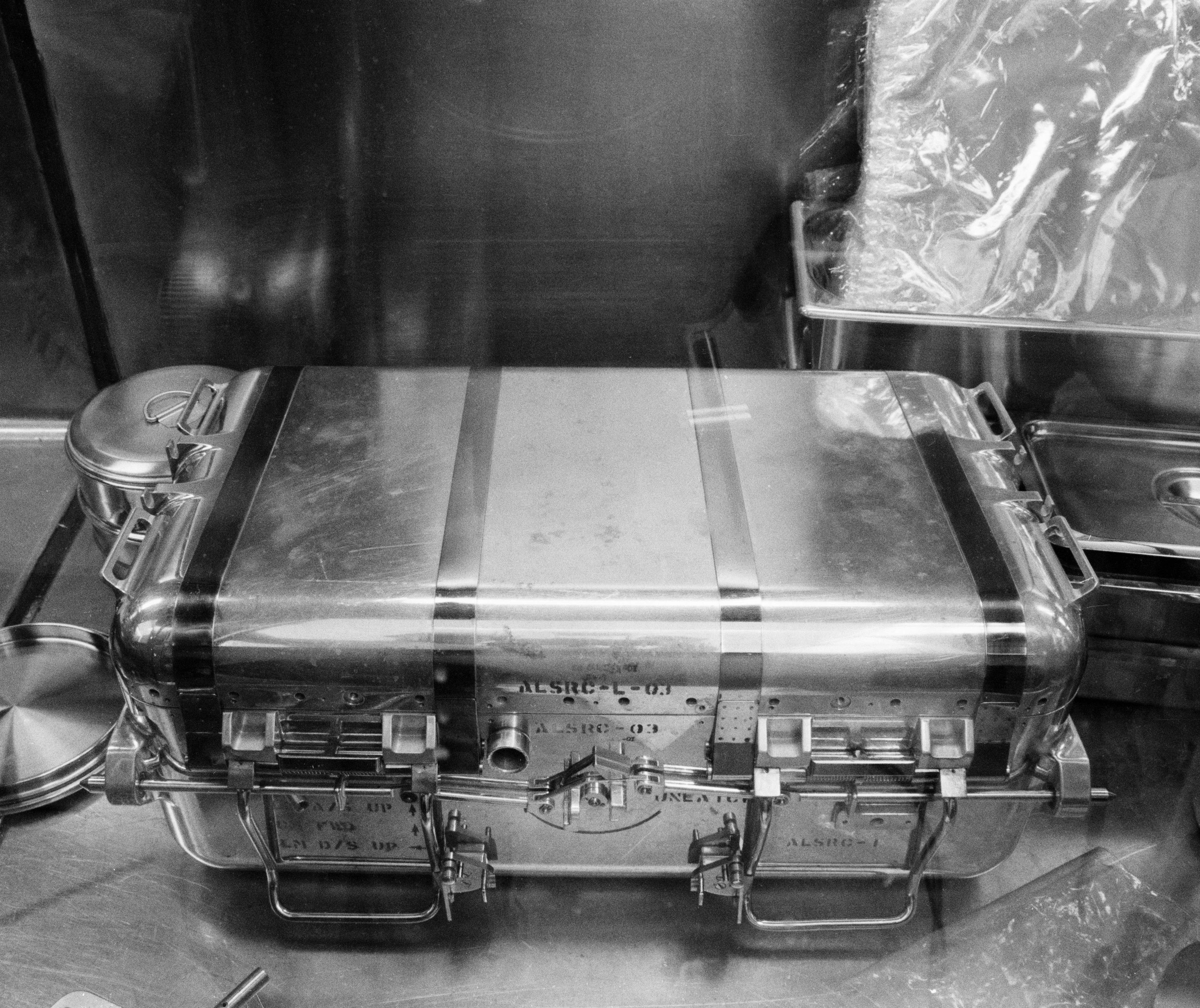 Aug. 5, 1969. In the Lunar Receiving Laboratory, scientists open the second Apollo 11 Lunar Sample Return Container and begin to examine the rock and soil samples