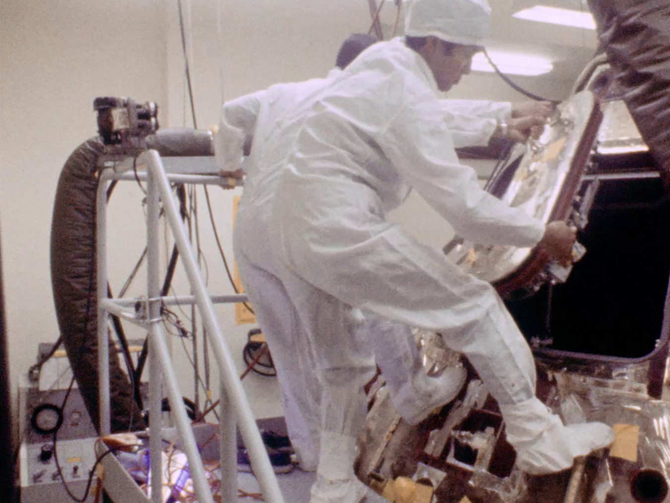 NASA engineer John K. Hirasaki opens the hatch to the Apollo 11 Command Module Columbia for the first time in the Lunar Receiving Laboratory (LRL) at the Manned Spacecraft Center, now NASA’s Johnson Space Center in Houston