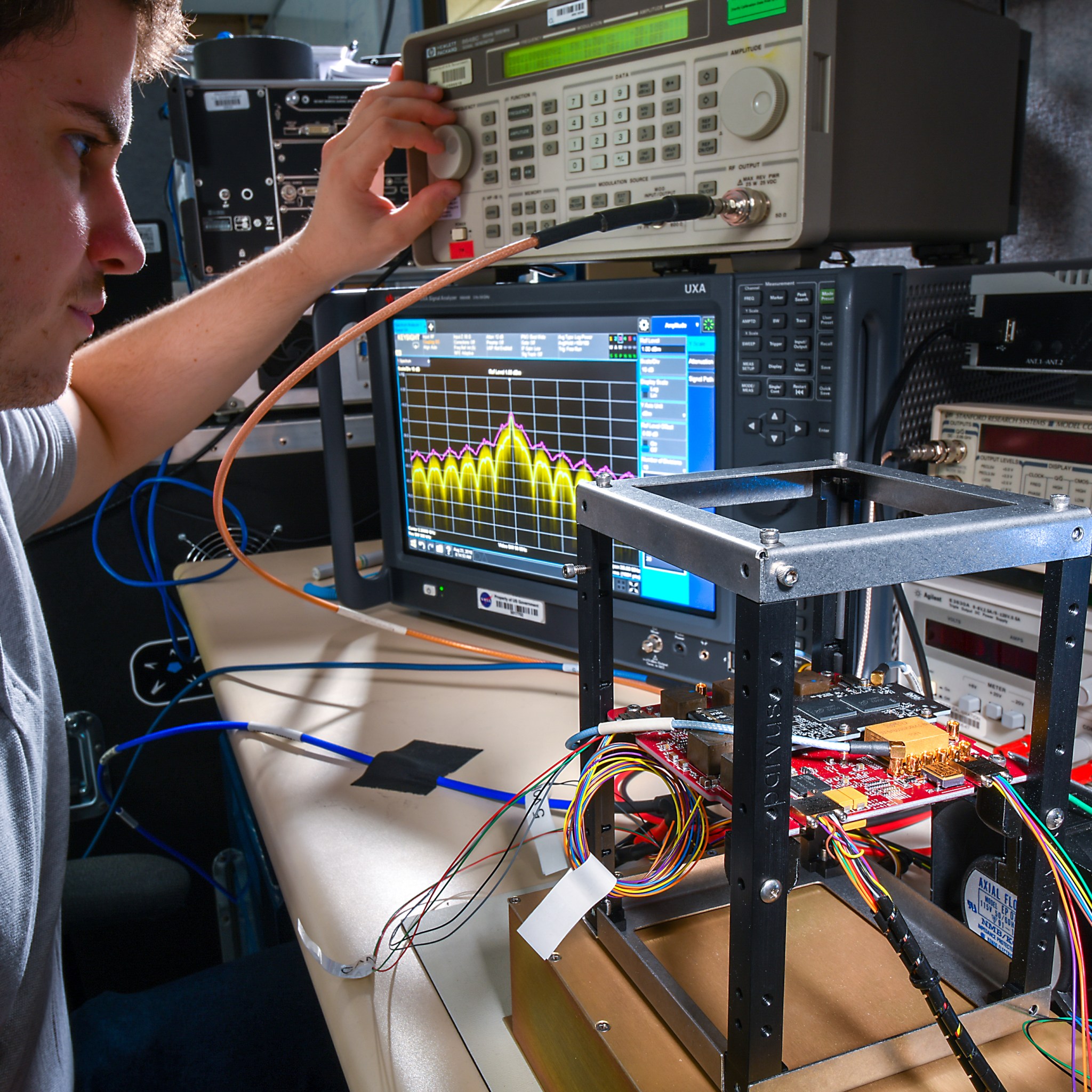 Up-close photo of an engineer working with diagnostics equipment to test CE-1 hardware.