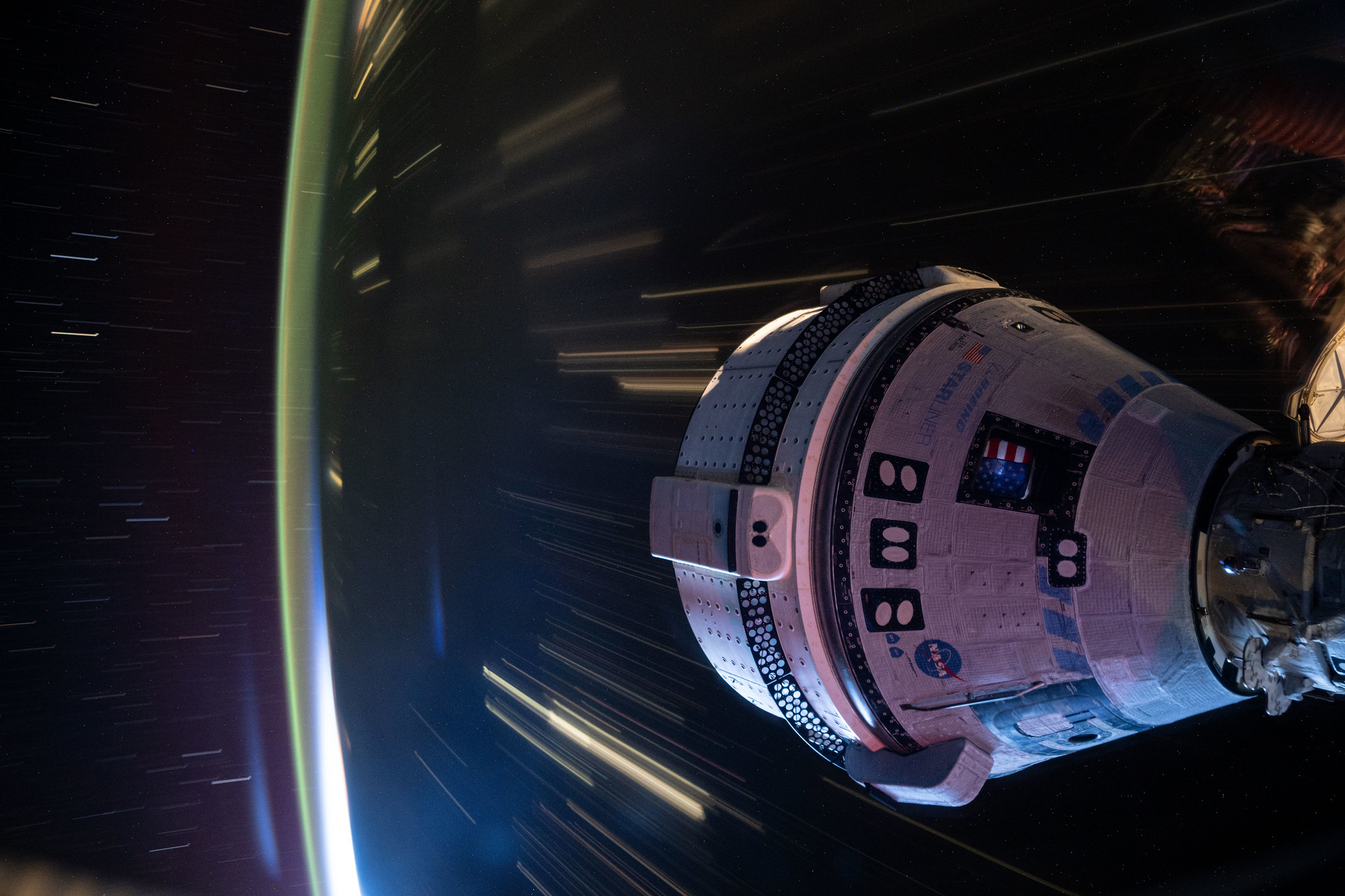 A long-duration image of Boeing's Starliner spacecraft docked to the International Space Station as it soared 258 miles above western China.