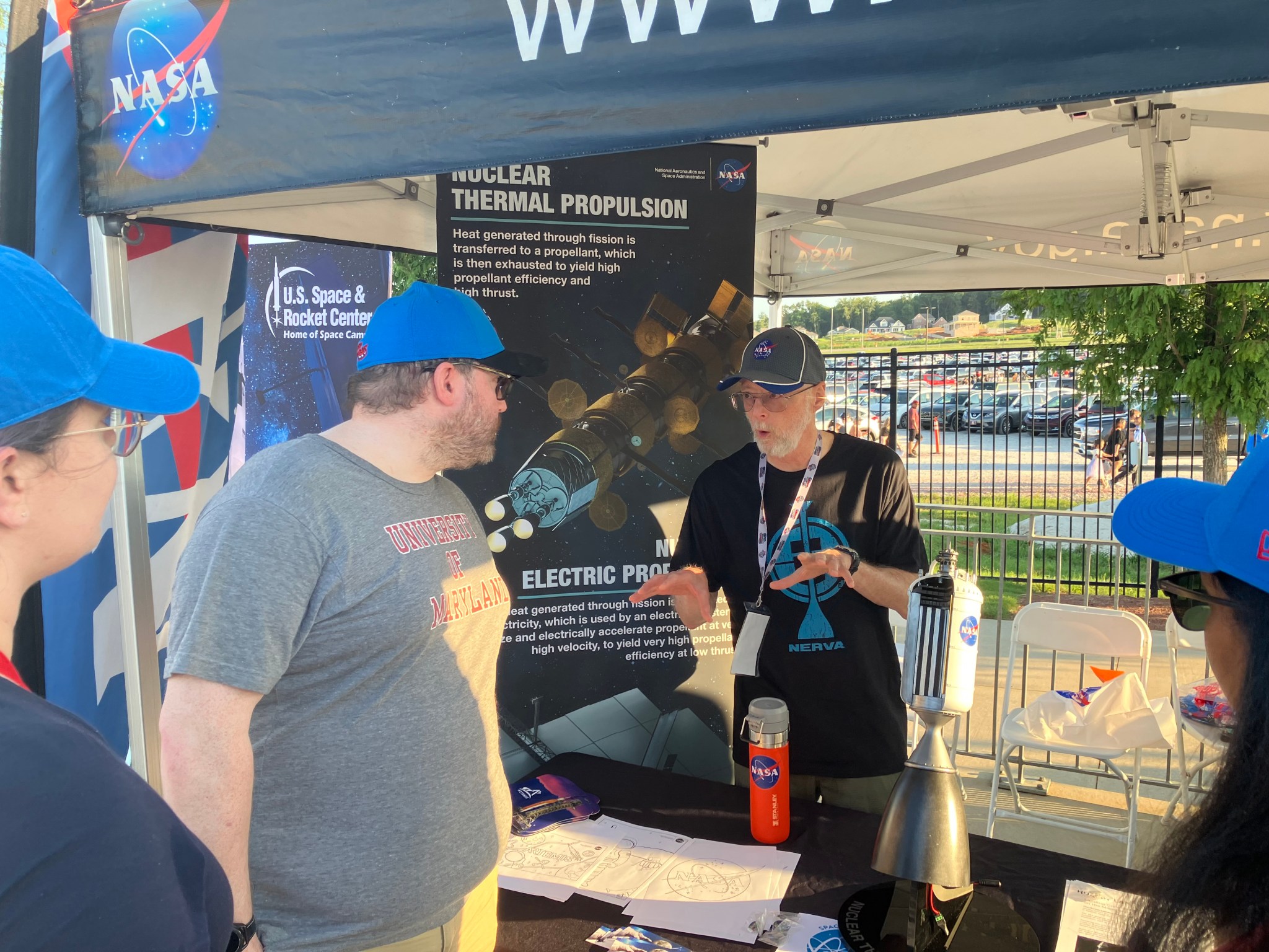 Dave Greeson, center, an aerospace engineer with the Space Nuclear Propulsion Office at Marshall, talks with fans during Space Night with the Rocket City Trash Pandas.