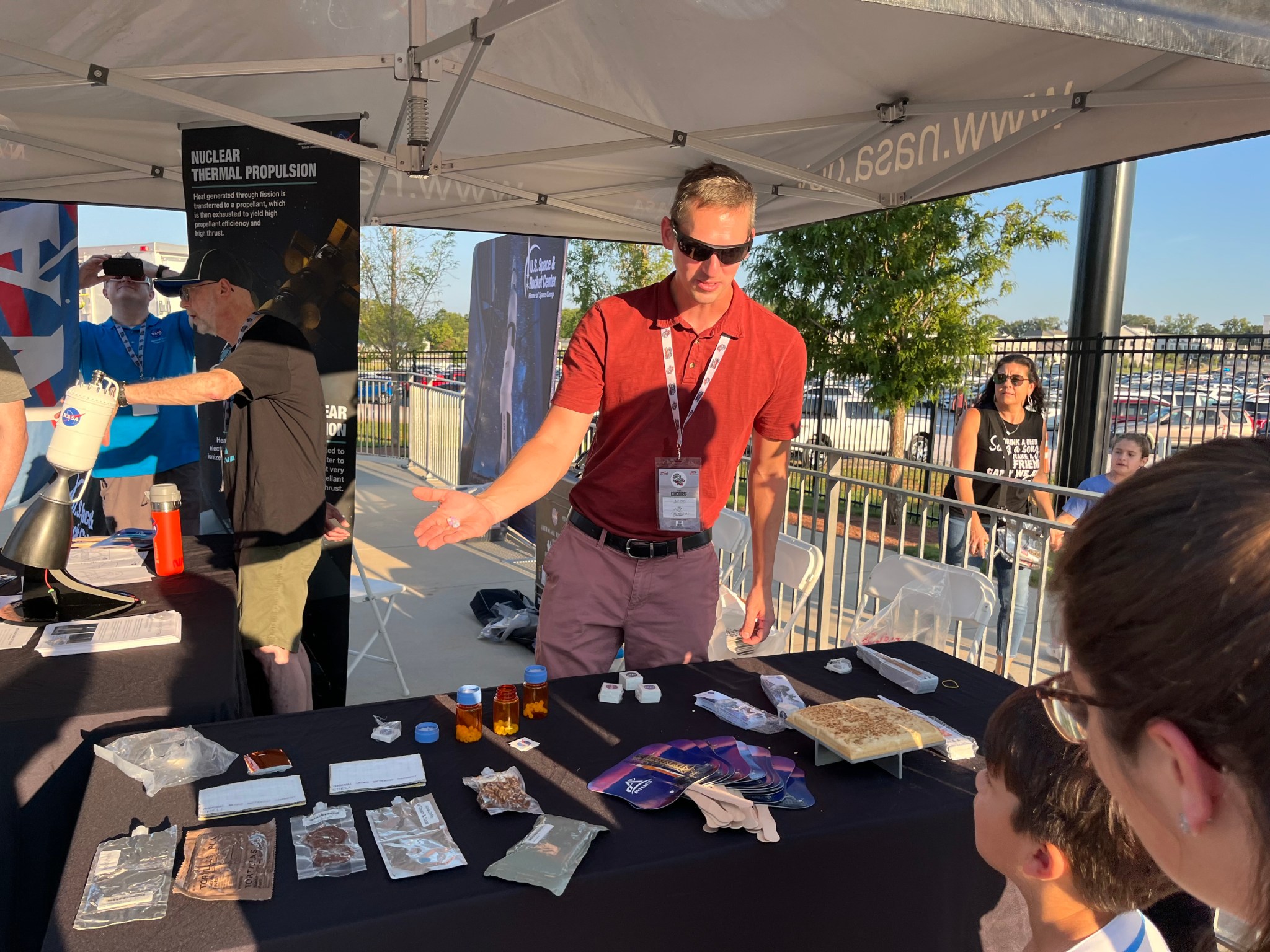 Dustin McMullen, lead ground systems engineer for the Human Landing System Program at Marshall, displays some astronaut food samples at Space Night.