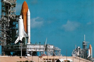 Space shuttle Discovery arrives at Launch Pad 39B, left, with space shuttle Endeavour still on Launch Pad 39A