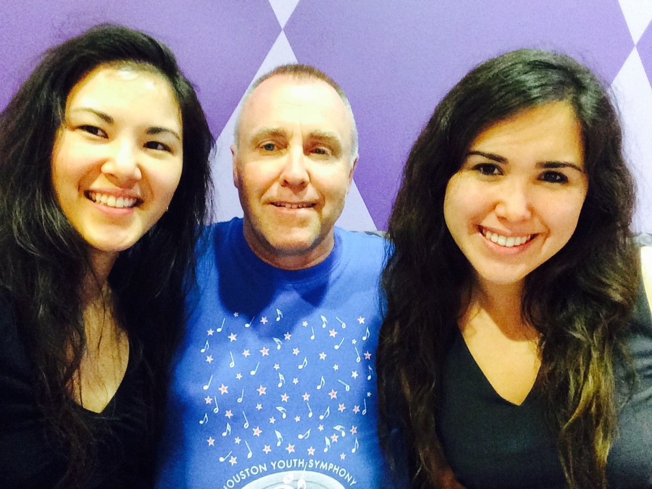 A NASA employee poses for a photo with his two grown daughters.