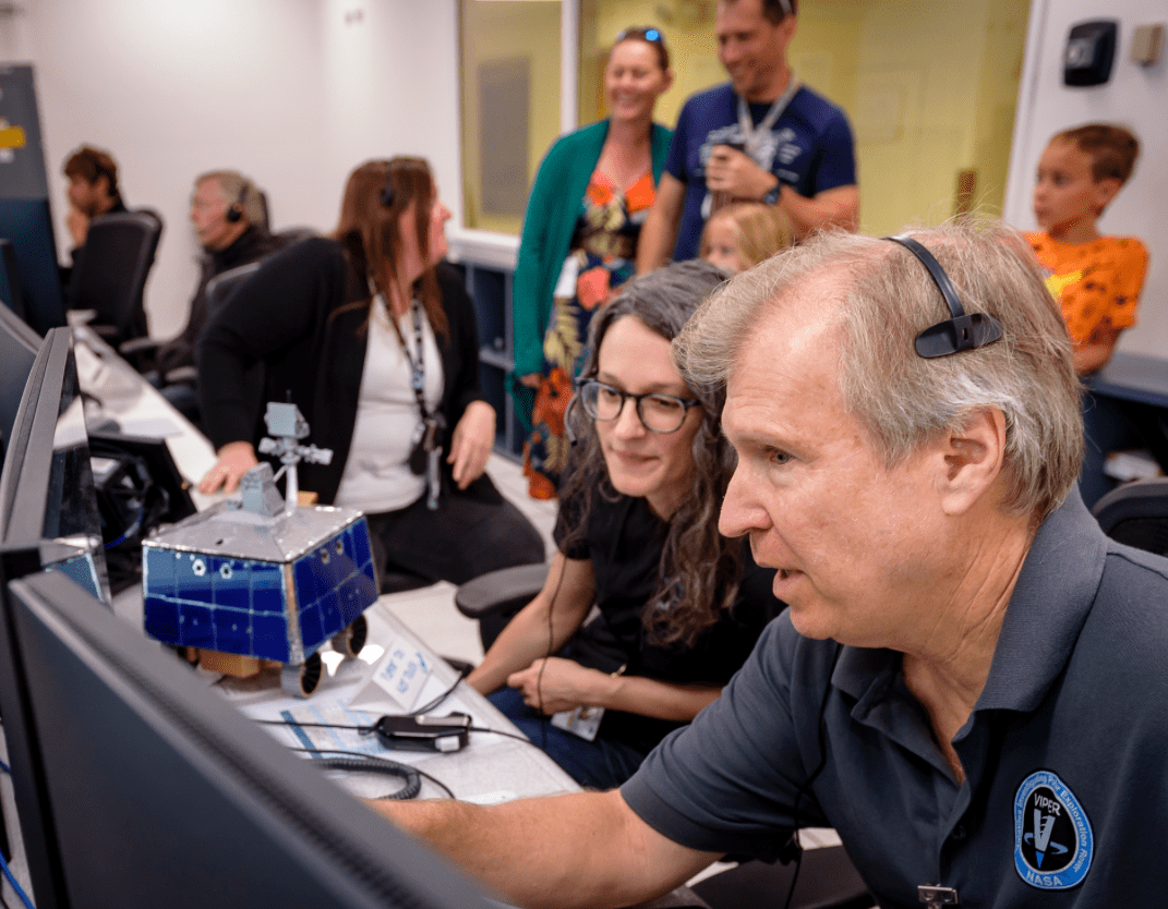 Right to left: Jay Trimble, Rachel Hoover, and Kelsey Herrmann in the Multi-Mission Operations Center (MMOC), N240, during the Volatiles Investigating Polar Exploration Rover (VIPER) Friends and Family Day.