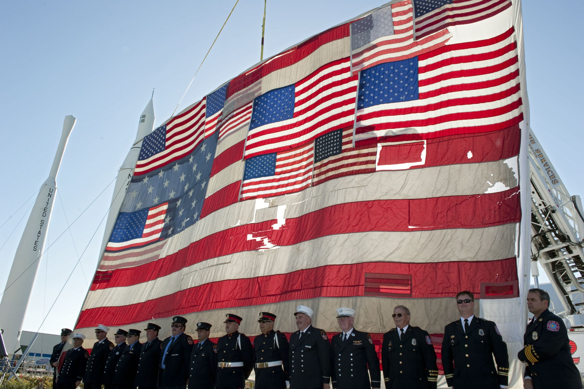 The National 9/11 Flag was raised over the Rocket Garden at the Kennedy Space Center Visitor Complex