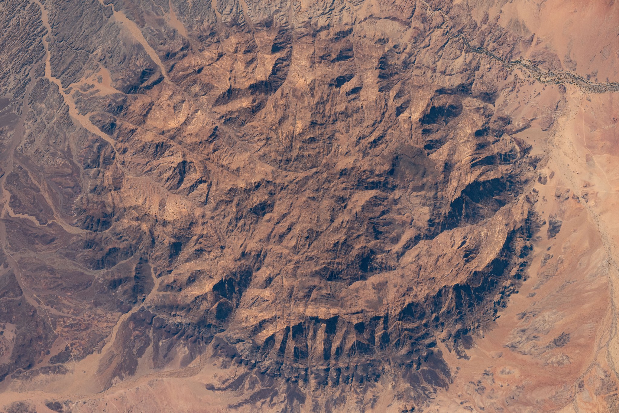 The dome-shaped Brandburg Massif, near the Atlantic coast of central Namibia, containing Brandberg Mountain, the African nation's highest peak and ancient rock paintings going back at least 2,000 years, is pictured from the International Space Station as it orbited 261 miles above.